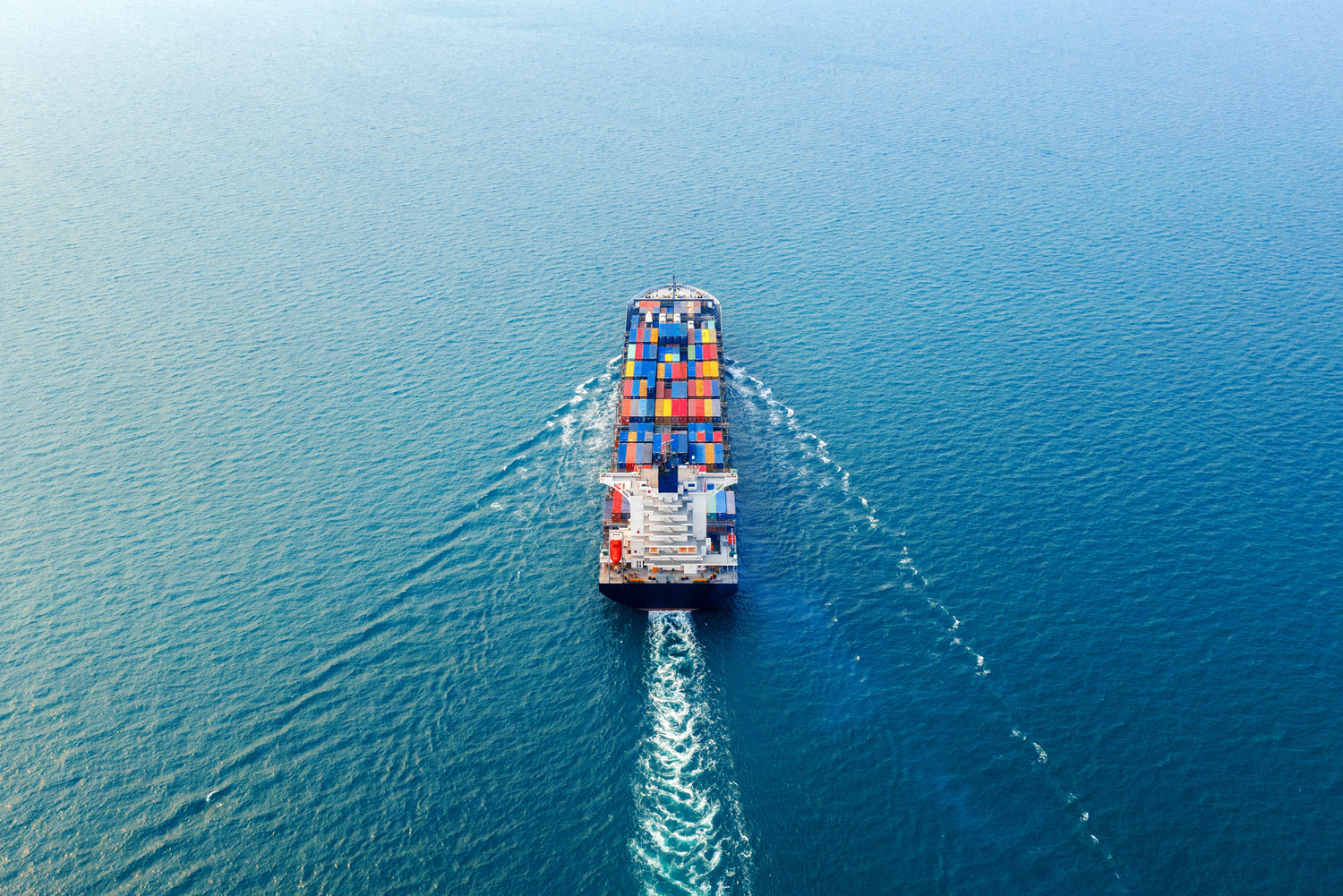 A cargo vessel making its way across the open sea